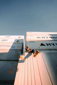 Person sitting on shipping container