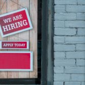 We are Hiring sign on door 